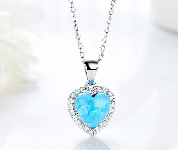 Stunning silver opal necklace for women featuring a heart-shaped blue opal pendant surrounded by sparkling gems