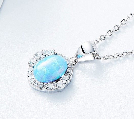 Elegant sterling silver opal necklace with a sparkling gemstone surrounded by clear stones