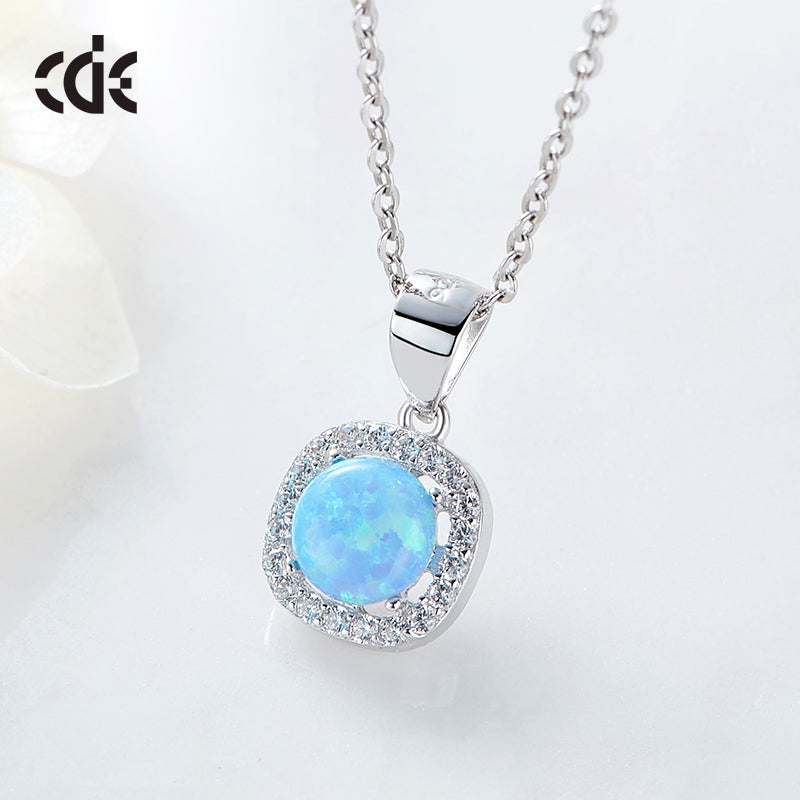 Elegant silver opal necklace featuring a blue opal pendant surrounded by sparkling accents. Buy silver opal necklace online.