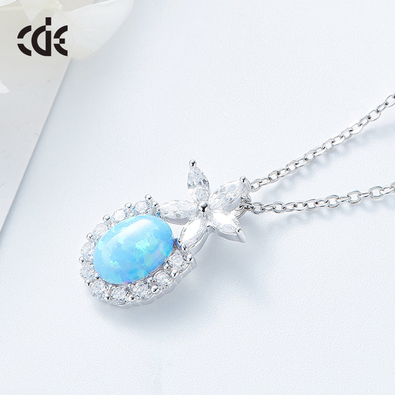 Cute flower opal pendant necklace with a shimmering blue opal and sparkling accents