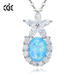 Cute flower opal pendant necklace featuring a blue opal and sparkling clear gemstones