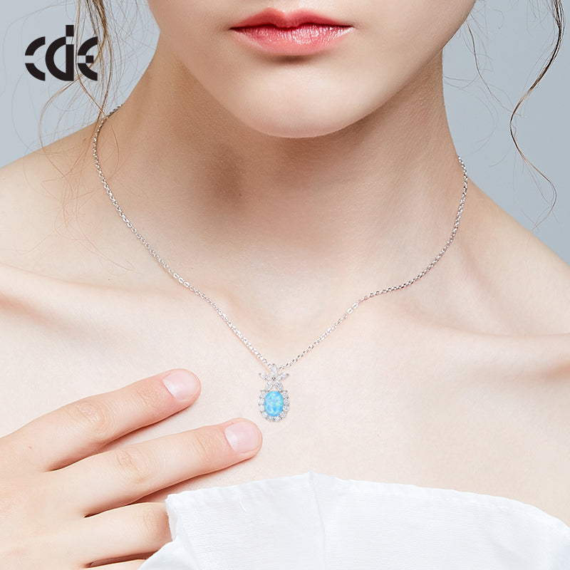 Cute flower opal pendant necklace on a model's neck, featuring a delicate silver chain