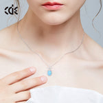 Cute flower opal pendant necklace on a model's neck, featuring a delicate silver chain