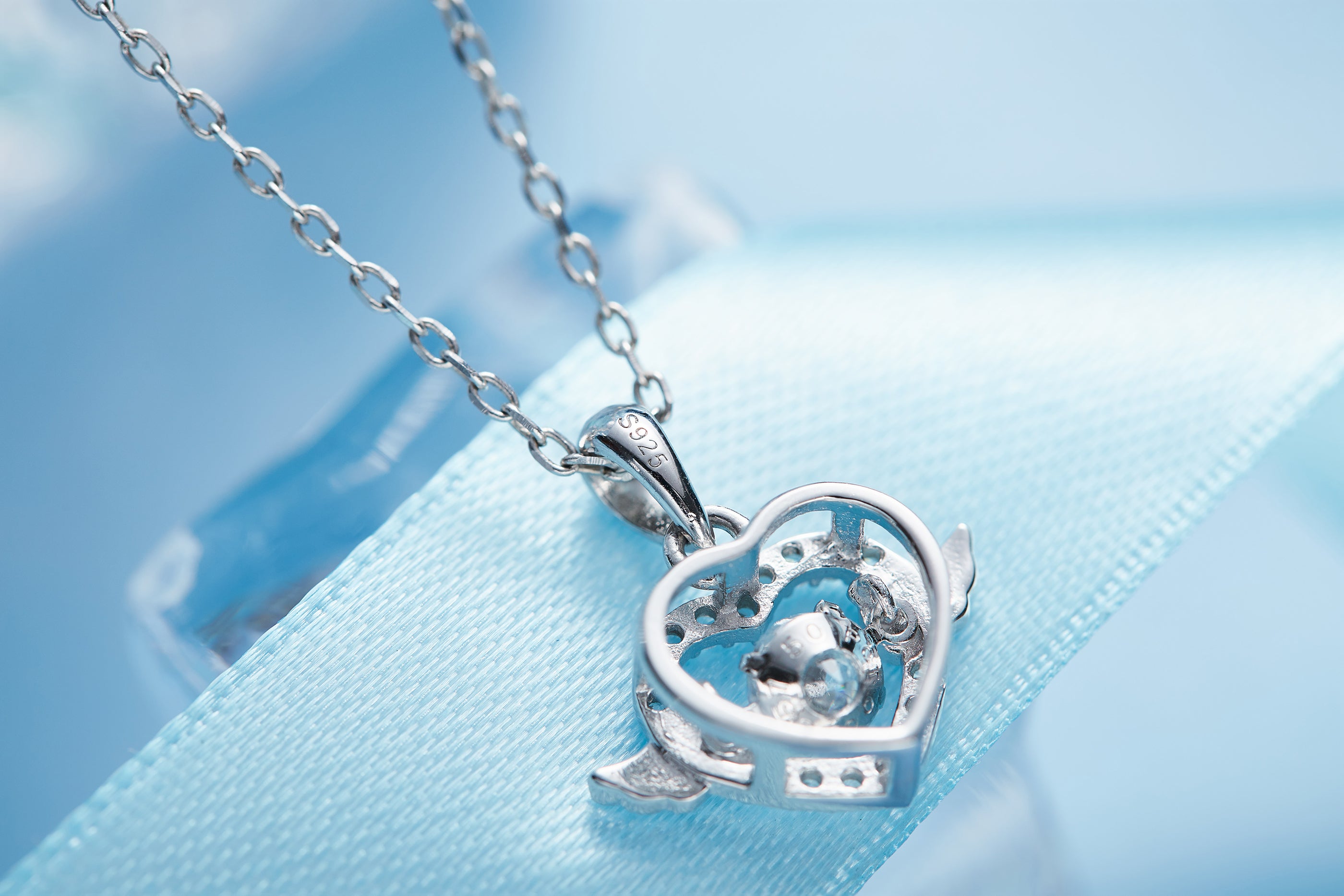 Sterling silver angel wing necklace with heart pendant on delicate chain