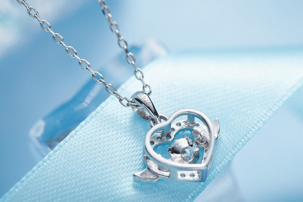 Sterling silver angel wing necklace with heart pendant on delicate chain