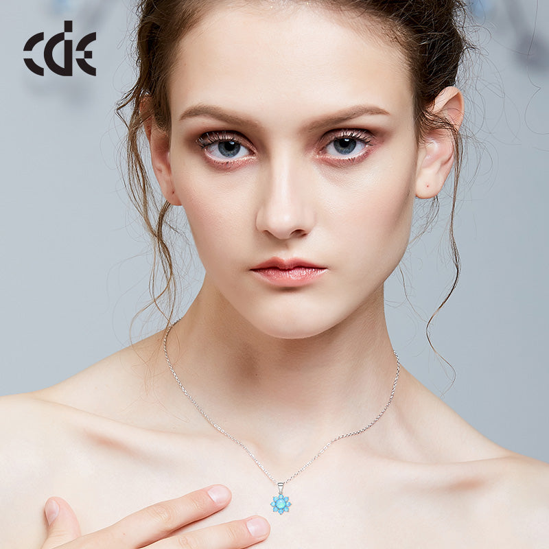 Sterling silver lab-created opal flower necklace worn by a model — Glintzia