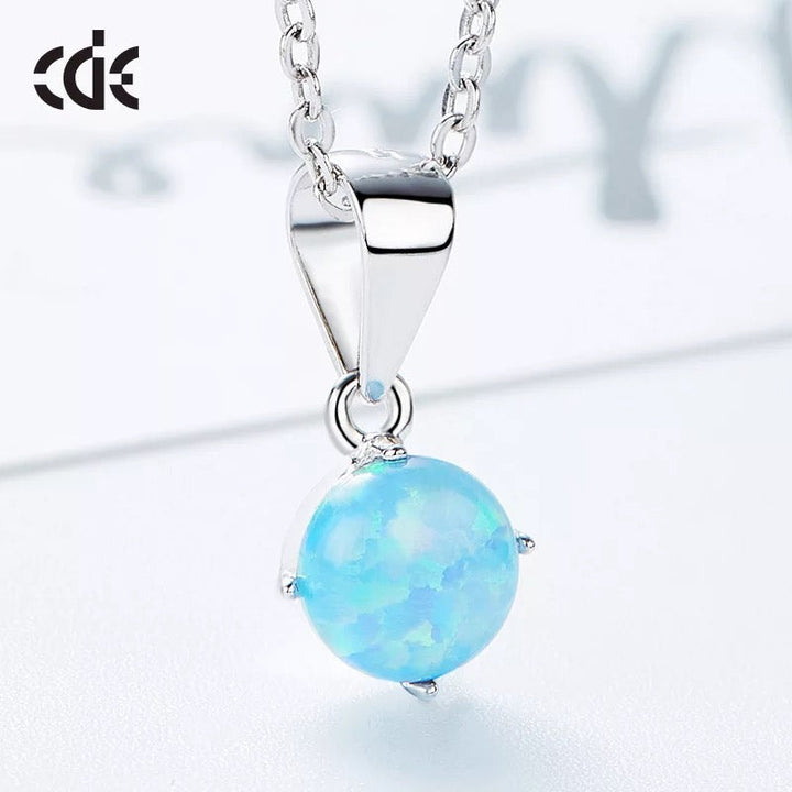 Sterling silver lab-created opal necklace with a vibrant blue pendant on a chic chain — Glintzia
