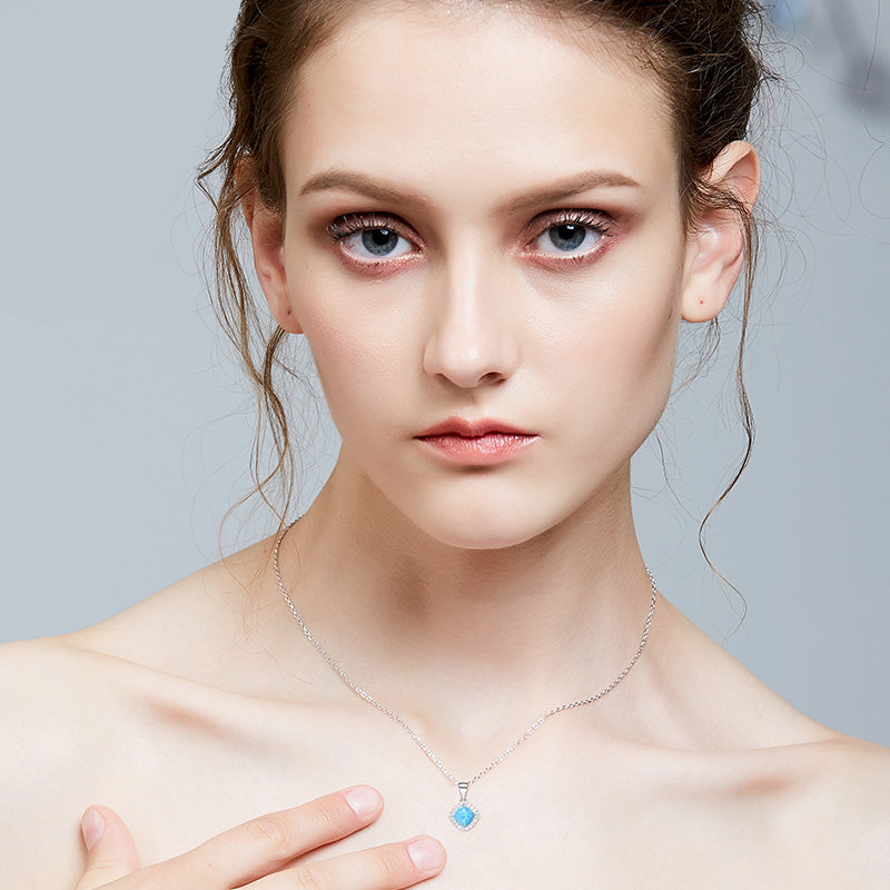 Sterling silver lab-created opal necklace on a model, shimmering blue design — Glintzia